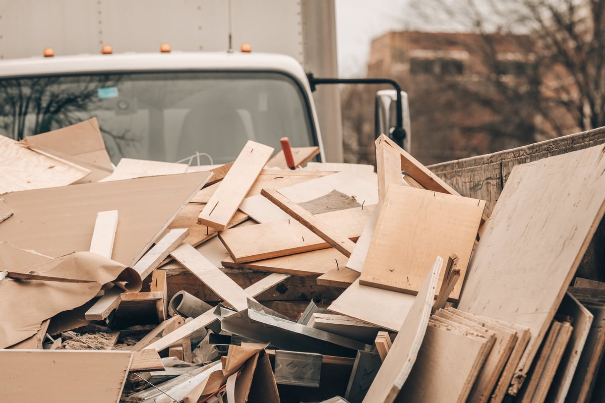 Junk removal crew loading debris into a work van